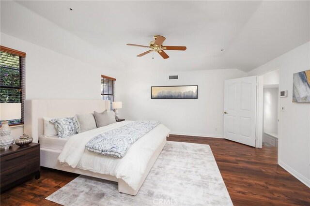 bedroom featuring multiple windows, wood finished floors, visible vents, and baseboards