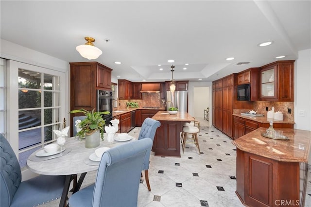 dining space with a tray ceiling, visible vents, and recessed lighting