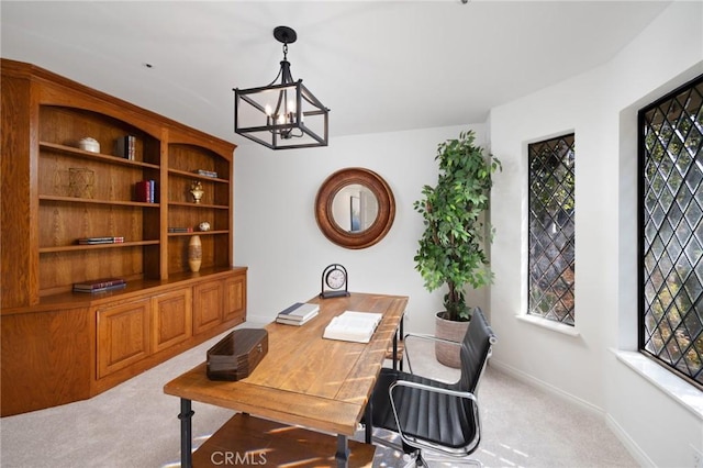 carpeted home office with an inviting chandelier, baseboards, and a wealth of natural light