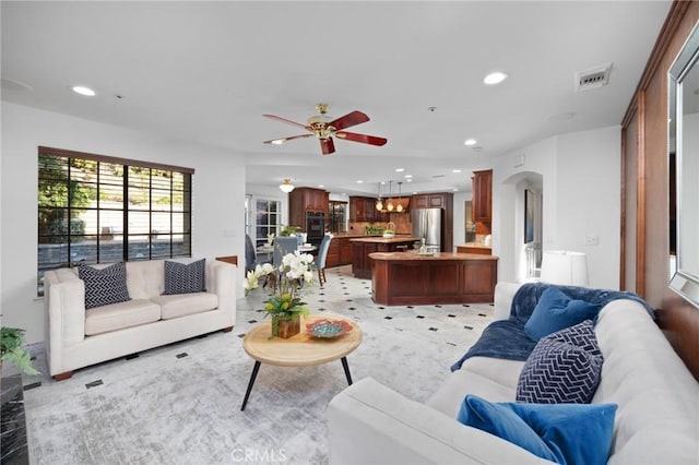 living room with arched walkways, ceiling fan, visible vents, and recessed lighting