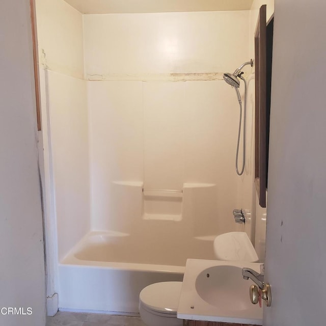 bathroom with toilet, vanity, and shower / washtub combination