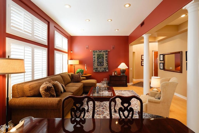 living area featuring decorative columns, recessed lighting, visible vents, wood finished floors, and baseboards