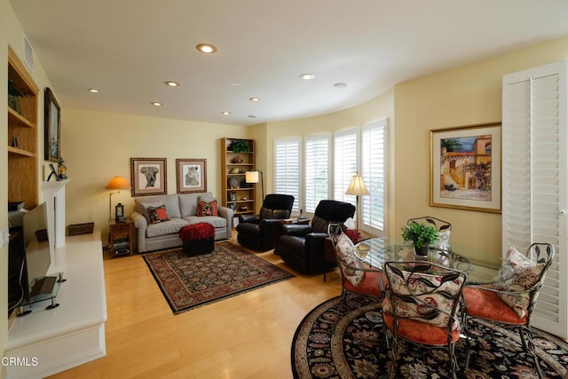 living room with light wood finished floors and recessed lighting