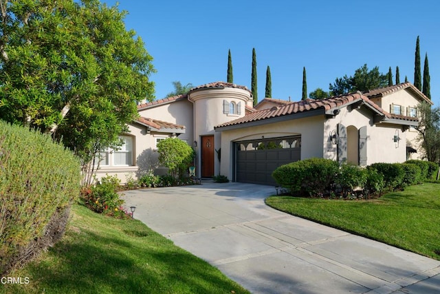 mediterranean / spanish-style house with an attached garage, a tile roof, driveway, stucco siding, and a front lawn