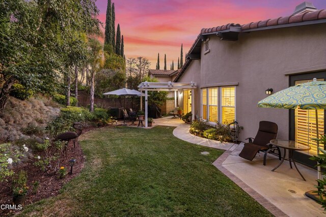 view of yard with a patio area, fence, and a pergola