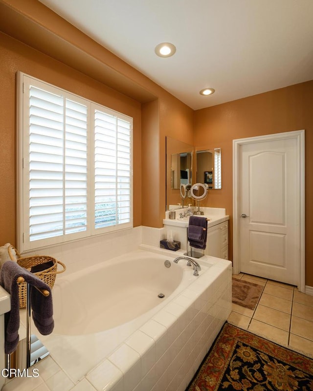 bathroom with recessed lighting, a garden tub, and tile patterned floors