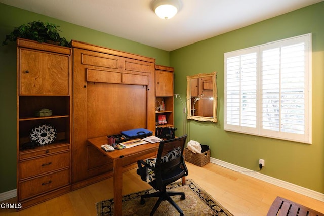 office area featuring baseboards and wood finished floors