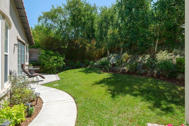 view of yard featuring a patio area and fence