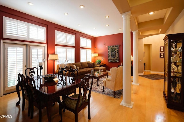 dining space featuring baseboards, light wood finished floors, decorative columns, and recessed lighting