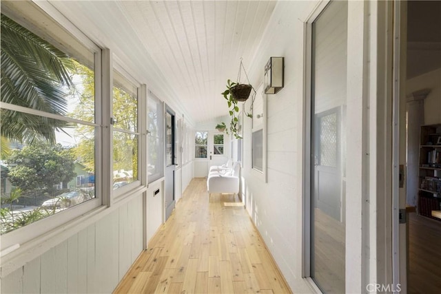 unfurnished sunroom with lofted ceiling and wooden ceiling