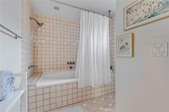 bathroom featuring tiled shower / bath combo and tile patterned flooring