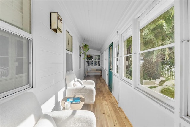 sunroom featuring lofted ceiling