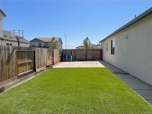 view of yard with a patio area and a fenced backyard