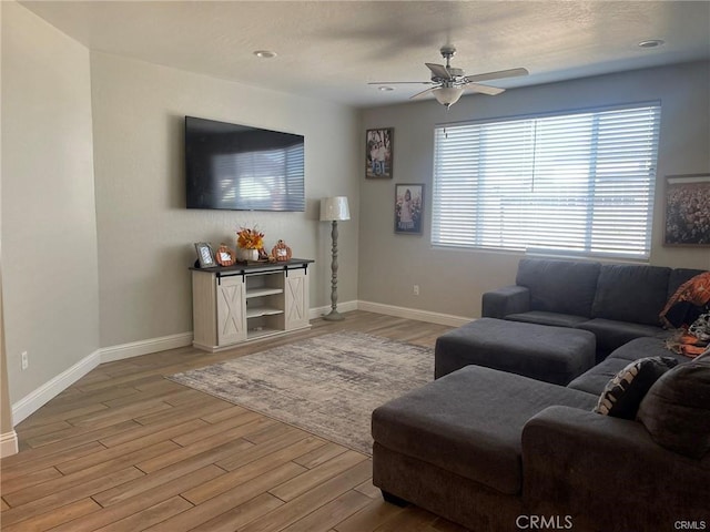 living room with a ceiling fan, light wood-type flooring, baseboards, and recessed lighting