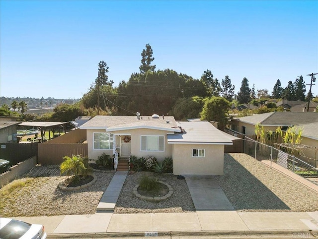 view of front of home with fence and stucco siding