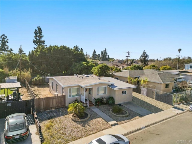 ranch-style home with fence and stucco siding