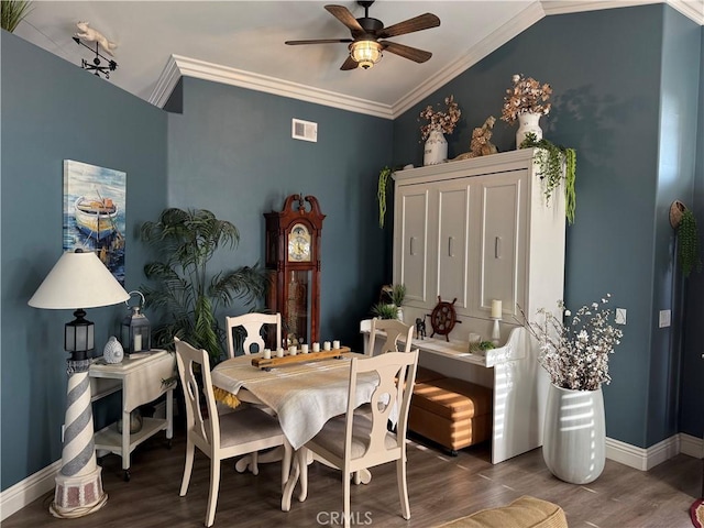 dining room with visible vents, ornamental molding, ceiling fan, wood finished floors, and baseboards