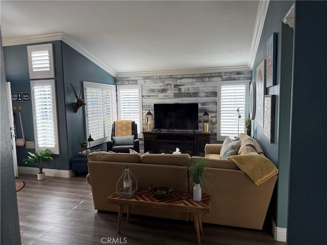 living area with lofted ceiling, crown molding, baseboards, and wood finished floors