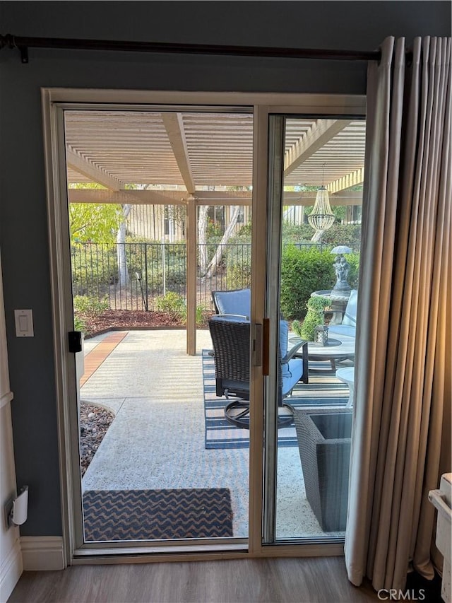 doorway to outside with baseboards, wood finished floors, and a healthy amount of sunlight