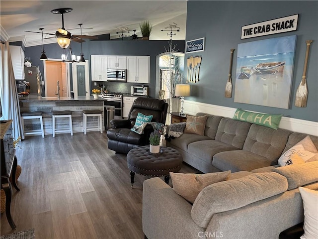 living room featuring a toaster, vaulted ceiling, dark wood finished floors, and a ceiling fan