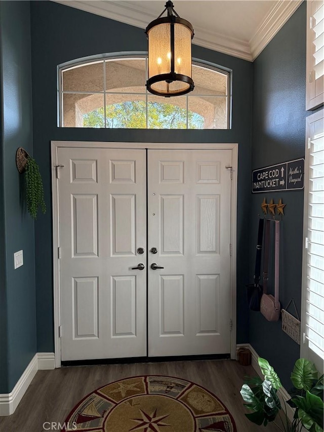 foyer featuring ornamental molding, plenty of natural light, and wood finished floors