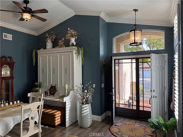 foyer entrance with wood finished floors, visible vents, baseboards, vaulted ceiling, and ornamental molding