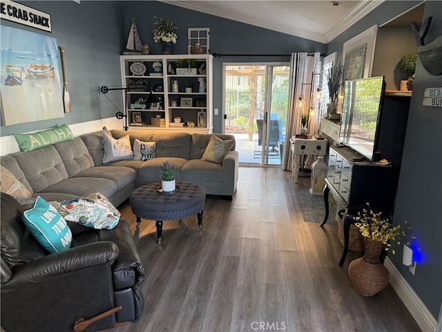 living area with lofted ceiling, baseboards, ornamental molding, and wood finished floors