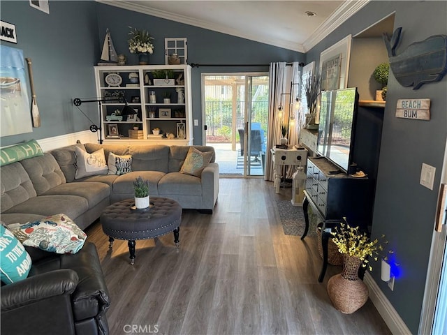 living area with ornamental molding, lofted ceiling, baseboards, and wood finished floors