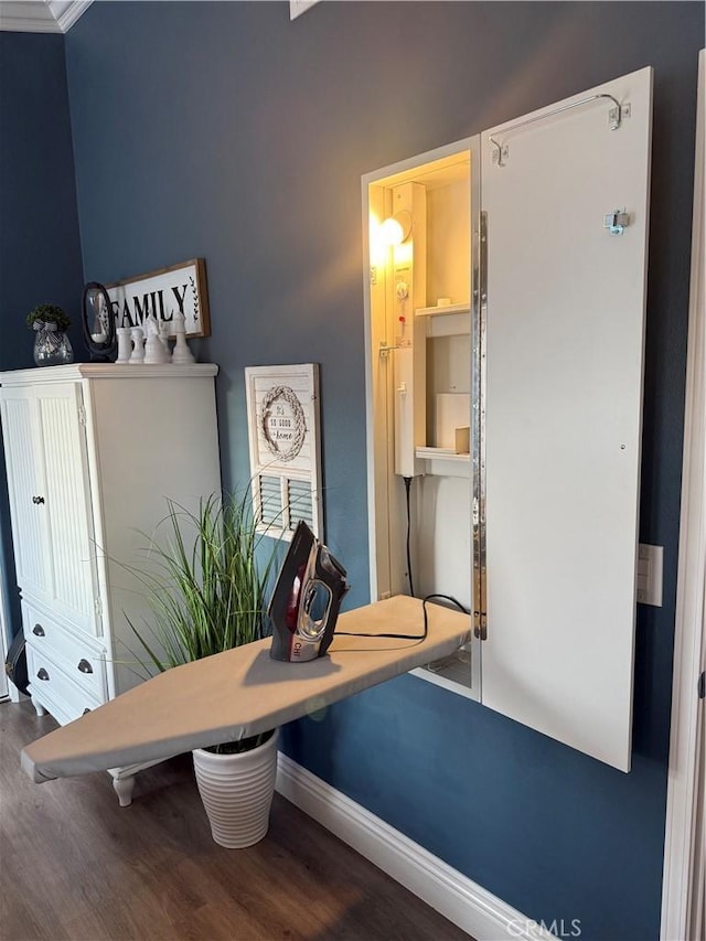 interior space featuring wood finished floors and baseboards