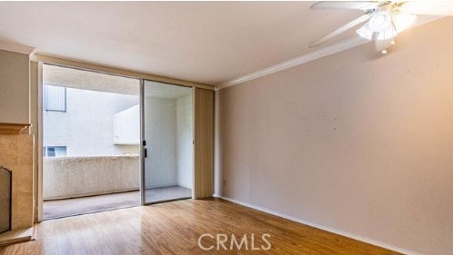 spare room featuring ornamental molding, ceiling fan, and wood finished floors