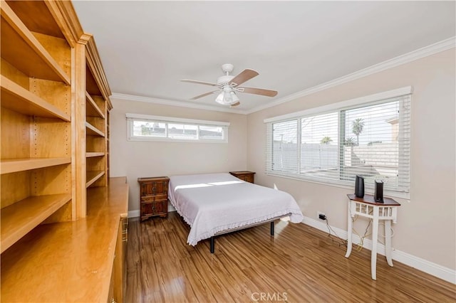 bedroom featuring ornamental molding, multiple windows, and wood finished floors