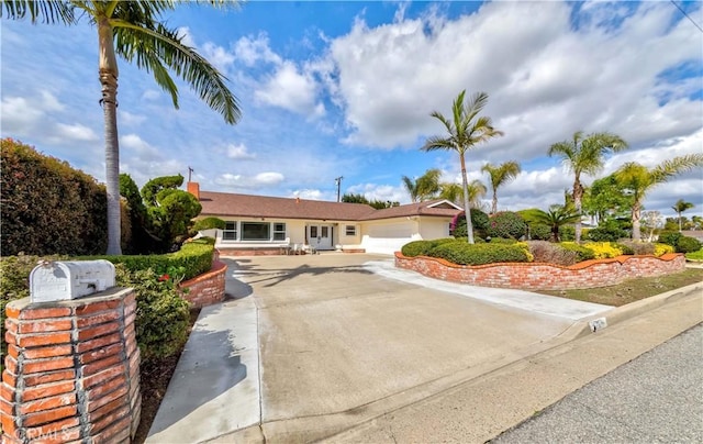 ranch-style home with driveway and an attached garage