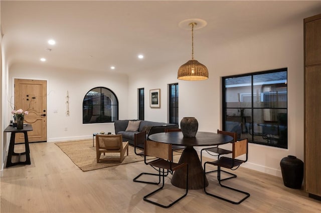 dining area with light wood-style flooring, baseboards, and recessed lighting