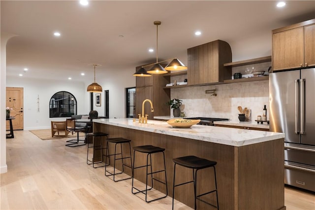 kitchen featuring open shelves, stainless steel appliances, recessed lighting, decorative backsplash, and light wood-style floors