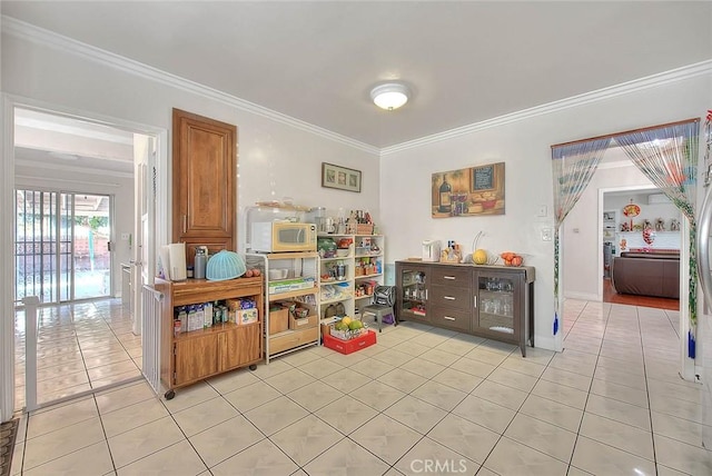 rec room featuring ornamental molding and light tile patterned flooring