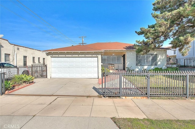 ranch-style house with a garage, a fenced front yard, concrete driveway, and stucco siding