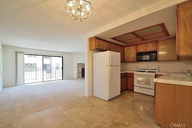 kitchen featuring tile countertops, white appliances, and brown cabinetry