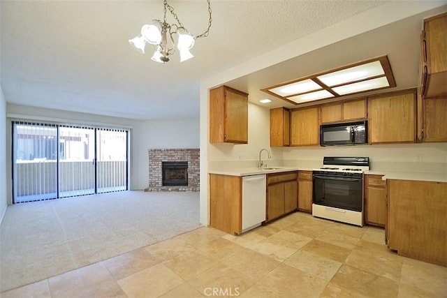 kitchen with white appliances, light colored carpet, open floor plan, brown cabinets, and a sink