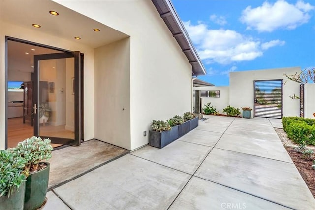 view of side of home with a patio area and stucco siding