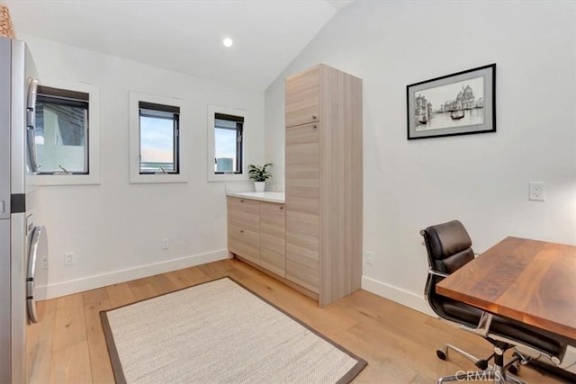 office space with light wood-style flooring, baseboards, vaulted ceiling, and recessed lighting