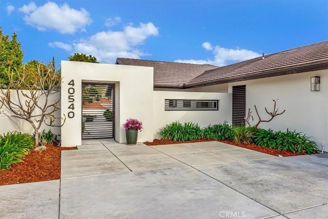 exterior space featuring fence and stucco siding