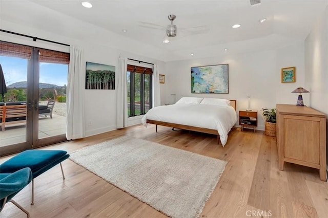 bedroom featuring access to exterior, light wood-type flooring, multiple windows, and recessed lighting