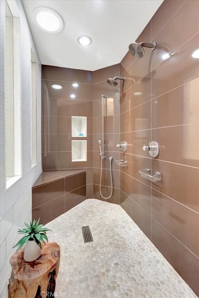 full bath with a tile shower