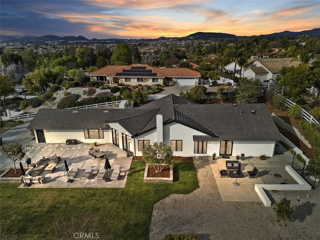 aerial view at dusk featuring a mountain view