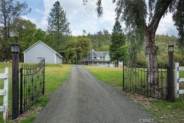 view of road featuring a gate, driveway, and a gated entry