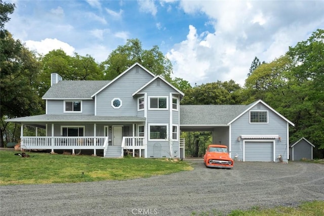 view of front facade featuring a porch, a garage, driveway, a chimney, and a front yard