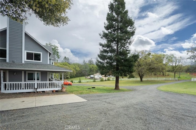 exterior space featuring driveway and a porch