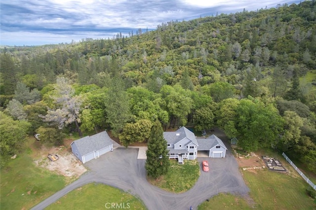 drone / aerial view featuring a forest view