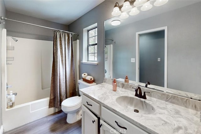 full bathroom with toilet, shower / bath combo, wood finished floors, and vanity