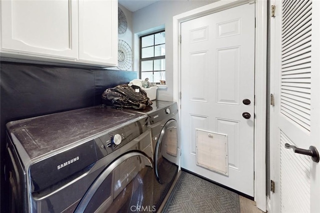 laundry area featuring washer and clothes dryer and cabinet space